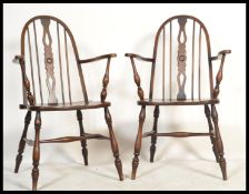 A good pair of 19th century revival beech and elm seated wheelback Windsor armchairs in the manner