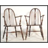 A good pair of 19th century revival beech and elm seated wheelback Windsor armchairs in the manner