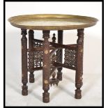 An early 20th century asiatic - anglo colonial folding Binares brass opium table. The base of