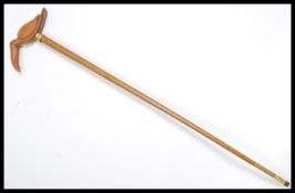 A vintage walking stick cane having a tapering Mal