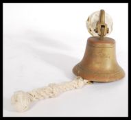 An early 20th century pre WW1 bronze ships bell with inscription for 1911 having a rope clapper.