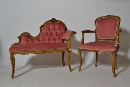 A 20th century French fauteuil armchair with show wood frame upholstered in a pink velour together