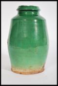 A 19th century large pottery vase having a green g