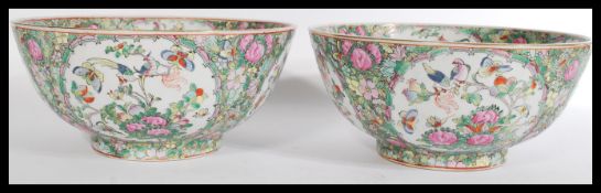 A pair of early 20th century Chinese large fruit bowls hand painted in a Famille rose pattern having