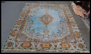 A large vintage 20th Century floor rug on a Royal blue ground, central medallion, with geometric