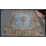 A large vintage 20th Century floor rug on a Royal blue ground, central medallion, with geometric