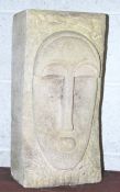An abstract carved Bath stone sculpture of a stylised face with cuboid shape.