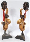 A pair of 20th century New Orleans negro band jazz - saxophone figurines - figure group. The body in
