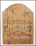 An antique retro wooden pub sign advertising point of sale for traditional real ales and bottles