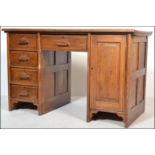 A 1920's Industrial solid oak twin pedestal office desk. One pedestal with bank of drawers and