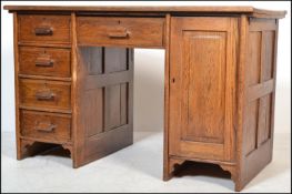 A 1920's Industrial solid oak twin pedestal office desk. One pedestal with bank of drawers and