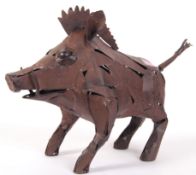 An unusual abstract garden art sculpture made from welded sheet steel in the form of a wild boar /
