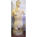 A large carved Bath stone sculpture of a nude women with a scar across where her left breast would