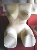 A large abstract carved Bath stone sculpture of a female torso in a seated position.