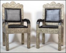 A pair of 20th century Moroccan throne chairs. Of large form with applied silver metal skins