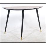 A vintage retro 20th century low tripod table having a leaf pattern top. The table raised on