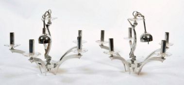 A pair of 1970's Scandinavian chrome ceiling chandeliers of angular form, each shaped arm