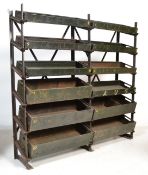 A vintage industrial metal storage rack unit having a ' x ' frame support and 12x angled slopes