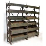 A vintage industrial metal storage rack unit having a ' x ' frame support and 12x angled slopes