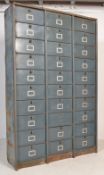 A large Industrial mid century 30 section fall front filing cabinet of metal construction having