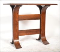 A 1970's teak wood Danish lamp - side table being raised on bentwood splayed leg supports united