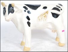 An unusual 20th century ex butchers shop large papier mache shop advertising model of a cow. Hand