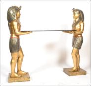 A 20th century ornate Egyptian style side table having a pair of pharaohs with the nemes headdress