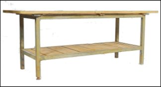 A large planked topped industrial metal framed table, the planked top being constructed from