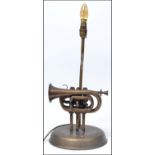 An unusual 20th century table lamp constructed from an upcycled  Boosey and Hawkes trumpet raised on