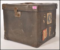 A vintage retro 20th century shipping trunk of cube form having original leather handle and brass