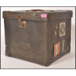A vintage retro 20th century shipping trunk of cube form having original leather handle and brass