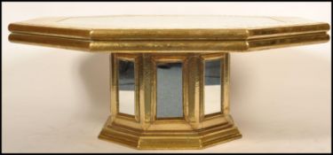 Attributed to Rodolfo Dubarry, a 20th century brass and mirror glass octagonal coffee occasional