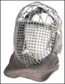 A 19th Century antique vintage steel and leather fencing mask, the steel rod being wrapped in wire