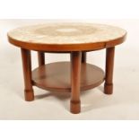 A 1960's retro vintage teak wood and marble coffee table raised on chunky cylindrical supports