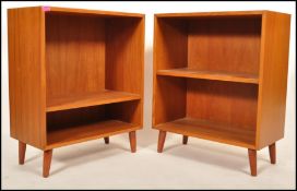 A pair of Danish 1970's teak wood open bookcase with a single shelf to each raised on short round