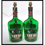 A pair of vintage VAT 69 Whisky bottles having a l