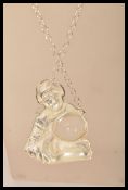 A silver plated large figural magnifying pendant i