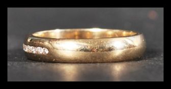 A hallmarked 9ct gold and diamond band ring having