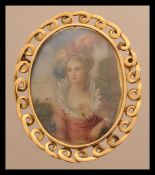 An 18ct gold brooch depicting a 19th century lady