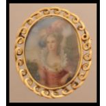 An 18ct gold brooch depicting a 19th century lady