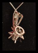 An 18ct white gold necklace pendant in the form of