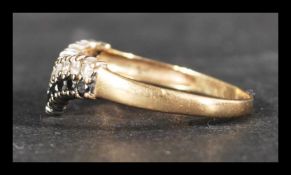 A hallmarked 9ct gold wishbone ring set with sapph