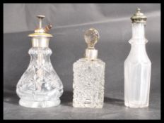A group of three glass bottles one with white meta