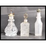 A group of three glass bottles one with white meta