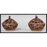 A pair of early 20th century carved coconut Potpou