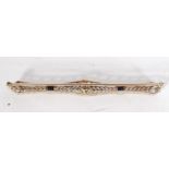 An 18ct white gold art deco bar brooch set with sa