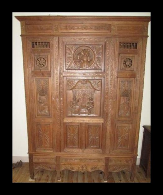 A 19th century French oak triple wardrobe armoire.