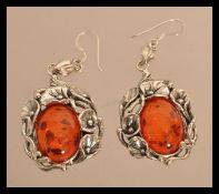 A pair of sterling silver and amber earrings havin