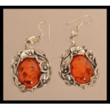 A pair of sterling silver and amber earrings havin