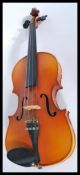 A vintage 20th century student violin with pierced